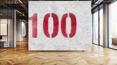 Red Number 100 on the white wall. Spray paint. Wall mural