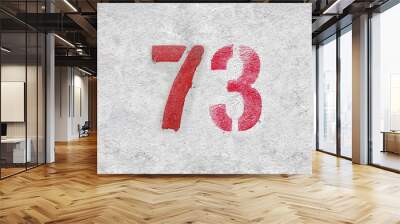 Red Number 73 on the white wall. Spray paint. Wall mural