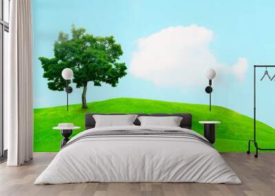 A view of beautiful green field with a tree and fresh grass on a sunny day Wall mural