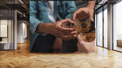 Alcoholic or party concept : Close up group of friend or colleague toasting glasses of alcohol whisky in pub or bar can use for party or celebrate concept. Wall mural