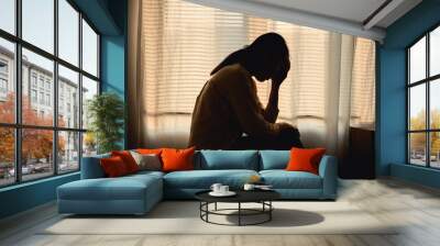 Silhouette photo of young Asian woman feeling upset, sad, unhappy or disappoint crying lonely in her room. Young people mental health care problem lifestyle concept.	 Wall mural