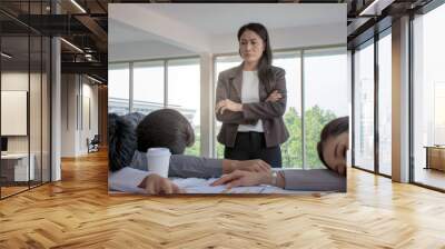 Picture of angry Asian boss watching employees sleeping in the office because overworked with too much Wall mural