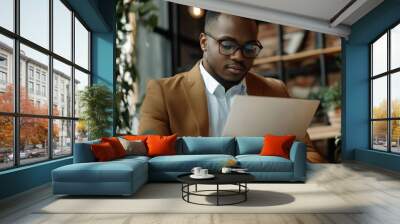 Black Man in a Brown Blazer Reading a Tablet Wall mural