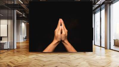 praying hands with faith in religion and belief in God on dark background. Wall mural