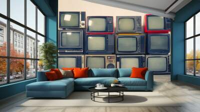 Retro old TVs pile on floor in the room. Television stack with vintage filter effect Wall mural