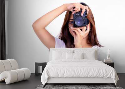 Woman taking a picture with vintage old camera isolated on white background Wall mural