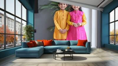 indian little sibling wearing traditional cloths standing together Wall mural