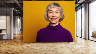 Mature woman smiling in purple, yellow backdrop. Photo generative AI Wall mural