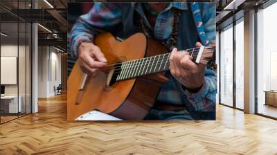 closeup of hands of old man playing on acoustic guitar in the street Wall mural