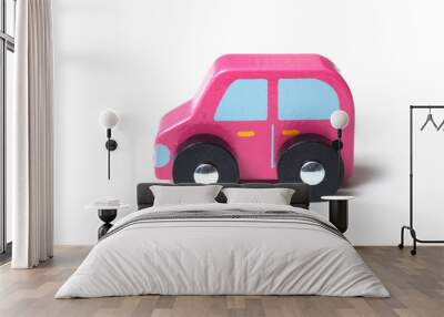 closeup of pink miniature wooden car on white background Wall mural