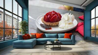 Closeup of strawberry tartlet with chantilly cream in a white plate on the table at therestaurant Wall mural