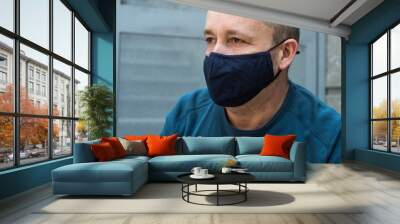 Portrait of man  with homemade fabric mask to protect against the coronavirus pandemic in outdoor Wall mural