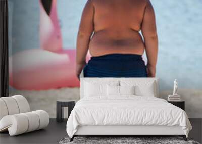 portrait of obese child on the beach on back view Wall mural