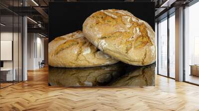 Group of two whole fresh baked rye wheat bread isolated on black glass Wall mural