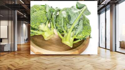 Group of two whole fresh green broccoli cluster on bamboo plate isolated on white background Wall mural