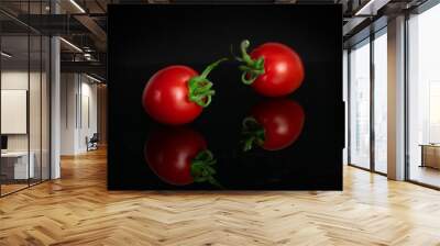 Group of two whole fresh red tomato cherry isolated on black glass Wall mural