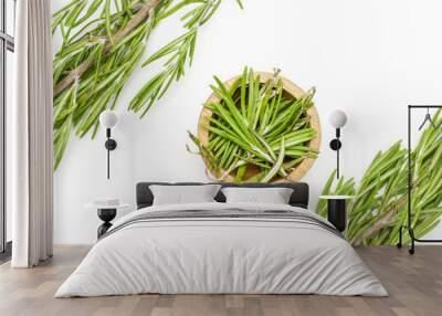 Group of two whole lot of pieces of fresh evergreen sprig of rosemary in a wooden bowl flatlay isolated on white background Wall mural