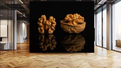 Group of two whole ripe brown walnut one is with half shell isolated on black glass Wall mural