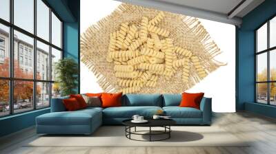 Lot of whole fresh raw pasta fusilli bucati on jute cloth flatlay isolated on white background Wall mural