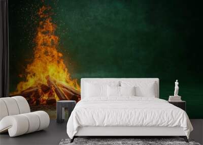 Vivid Campfire Flames Against a Green Background Wall mural