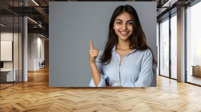 Confident smiling indian young woman professional student customer saleswoman looking at camera pointing at sales copy space isolated on grey studio background, happy lady, Generative AI  Wall mural