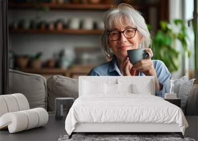 Smiling mature elder 60s woman sitting relaxing with cup of tea, coffee. Senior mid age stylish look woman with eyeglasses portrait with cup looking away at modern, Generative AI  Wall mural