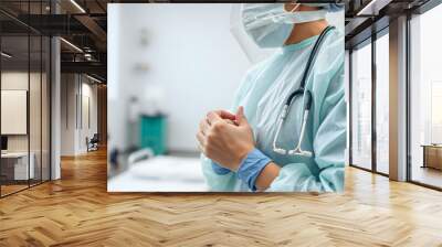 Physiotherapist wears disposable gown. Preparation for rehabilitation therapy with personal protective equipment. Medicine and health in coronavirus times (covid-19) isolated with white highlights,  Wall mural