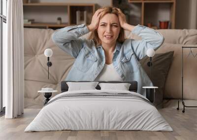 Adult woman suffering from headache at home Wall mural