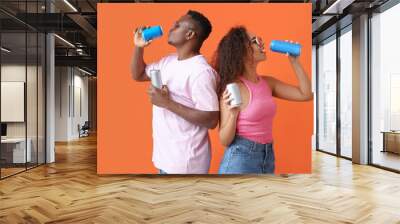 African-American couple with soda on color background Wall mural