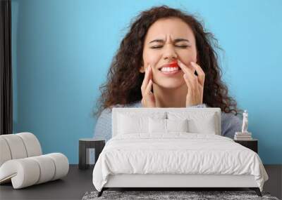 African-American woman with gum inflammation on color background Wall mural