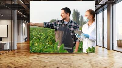 Agricultural engineers working in field Wall mural