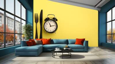 Alarm clock and cutlery on color background. Diet concept Wall mural