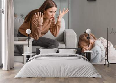 Angry mother threatening her daughter at home Wall mural