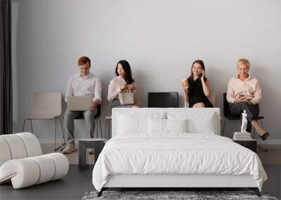 Applicants waiting for job interview near light wall Wall mural