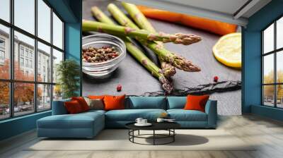 Asparagus with spices on dark background Wall mural