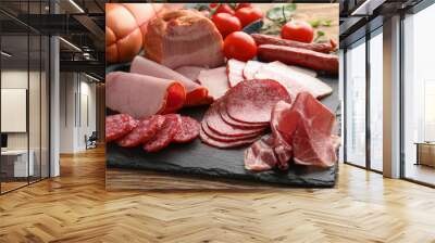 Assortment of delicious deli meats on slate plate Wall mural