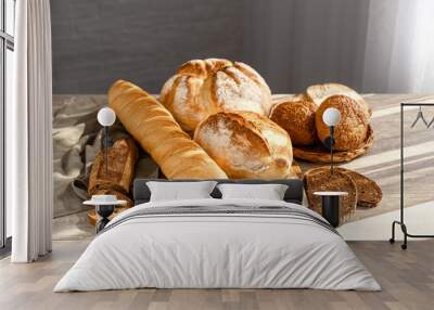 Assortment of fresh bread on table Wall mural