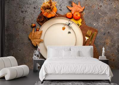 Autumn table setting with pumpkins and leaves on dark grunge background Wall mural