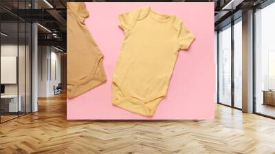 Baby clothes on color background Wall mural