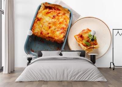 Baking dish and plate with tasty enchilada on white background Wall mural