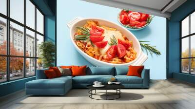 Baking dish of pasta with tomato sauce and cheese on blue background Wall mural