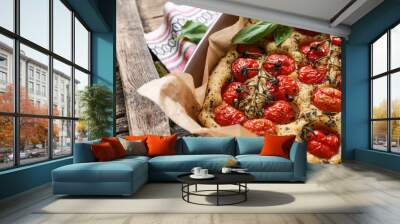 Baking dish with tasty Italian focaccia on wooden table Wall mural