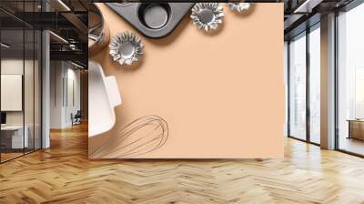 Baking forms and utensils on beige background Wall mural