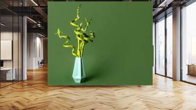 Bamboo plant in vase on green background Wall mural