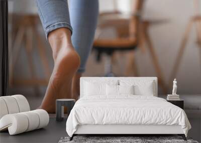 Bare foot of young woman walking at home, closeup Wall mural