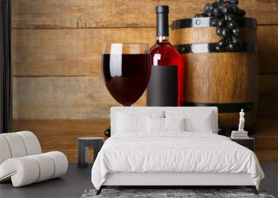 Barrel with glass and bottle of exquisite wine on wooden background Wall mural