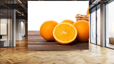 Basket with fresh ripe oranges on wooden table against white background, closeup Wall mural