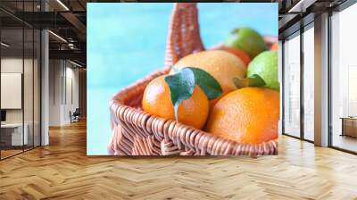 Basket with ripe citrus fruits, closeup Wall mural