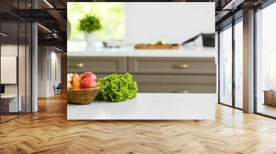 Basket with vegetables on table in modern kitchen Wall mural