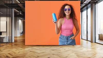 Beautiful African-American woman with soda on color background Wall mural